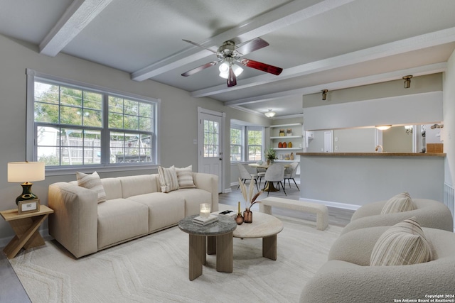 living room featuring beamed ceiling, ceiling fan, and hardwood / wood-style flooring