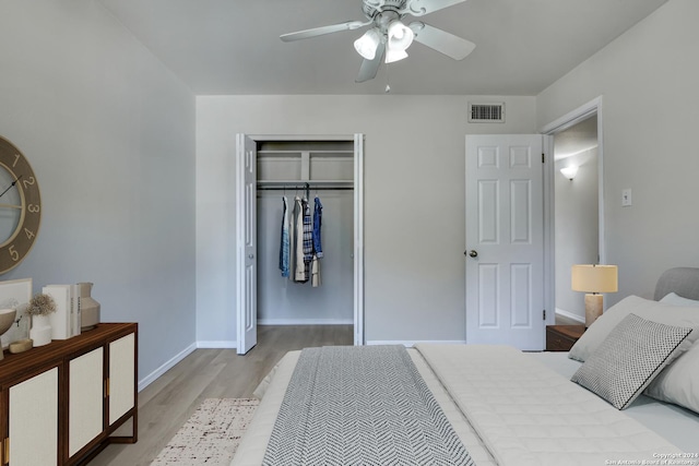 bedroom with ceiling fan, a closet, and light hardwood / wood-style flooring