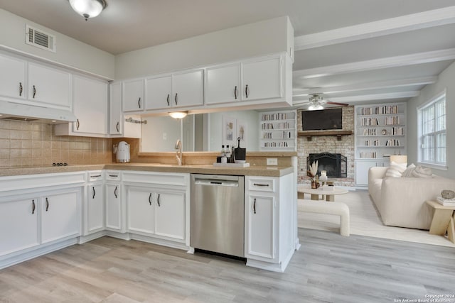 kitchen featuring dishwasher, decorative backsplash, light wood-type flooring, a fireplace, and white cabinetry