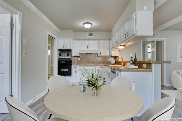 interior space featuring light wood-type flooring, sink, and ornamental molding