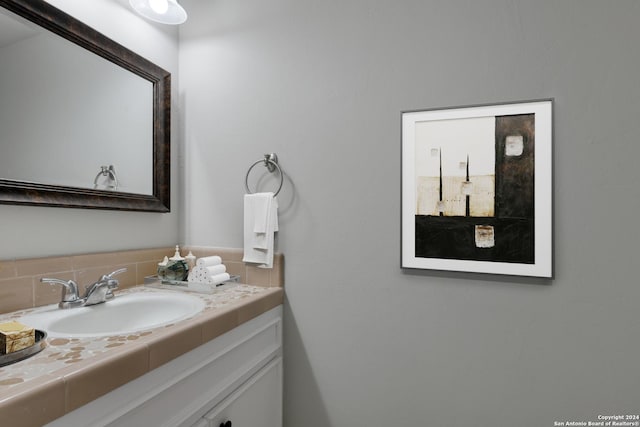 bathroom with decorative backsplash and vanity