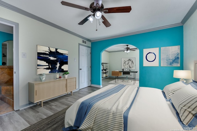 bedroom with ceiling fan, hardwood / wood-style floors, and ornamental molding