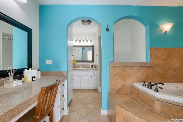 bathroom featuring tile patterned floors, tiled tub, and vanity