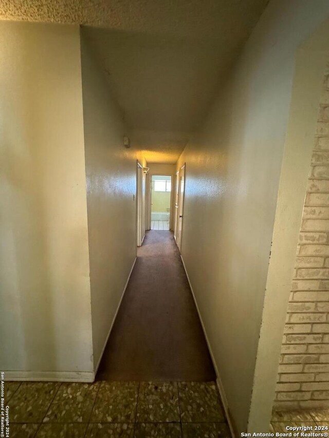 hallway with vaulted ceiling