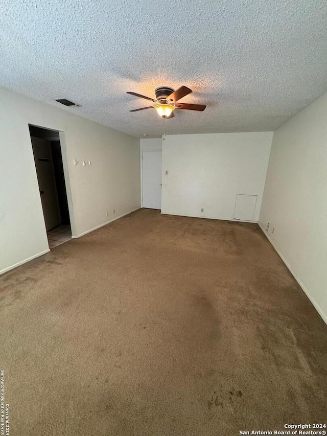 unfurnished room featuring carpet, a textured ceiling, and ceiling fan