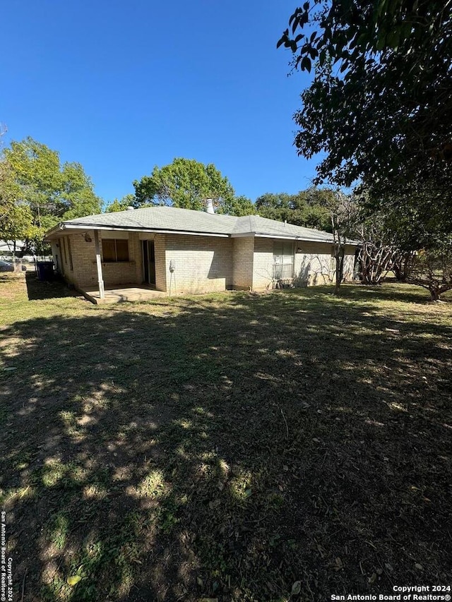 view of side of home featuring a lawn