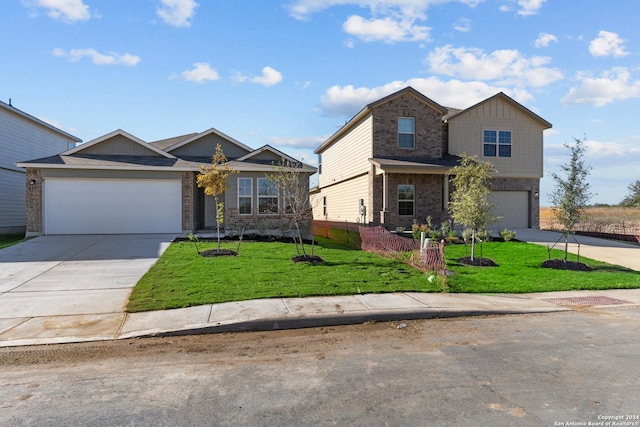 view of front facade featuring a garage, concrete driveway, fence, a front yard, and brick siding