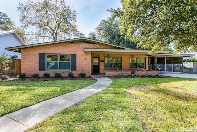 view of front facade with a front lawn and a carport