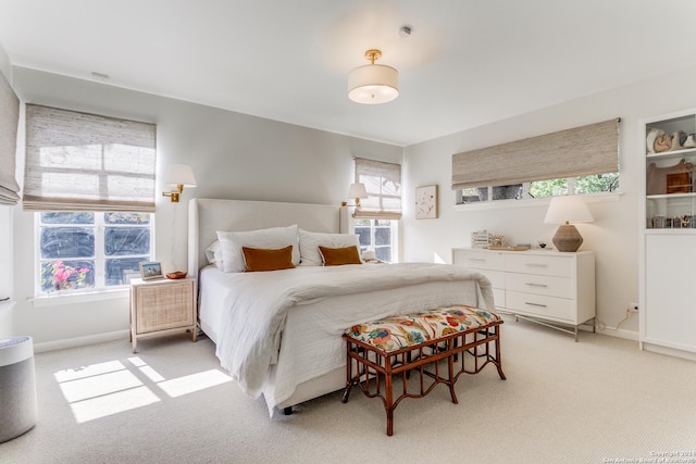 carpeted bedroom with multiple windows