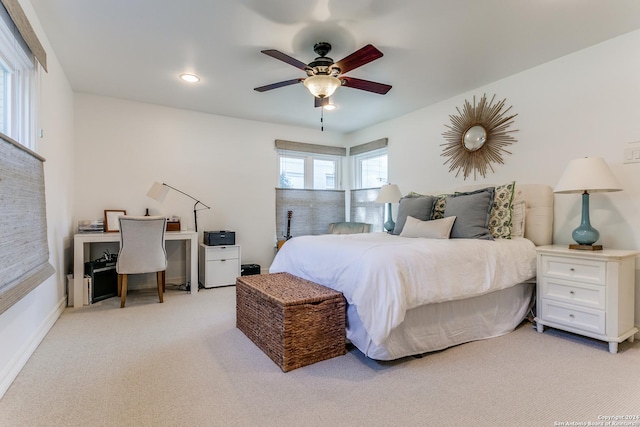 bedroom with ceiling fan and light colored carpet