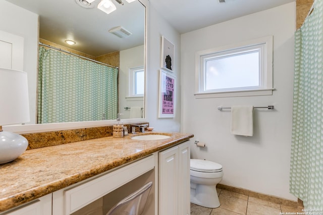 bathroom featuring toilet, vanity, and tile patterned floors