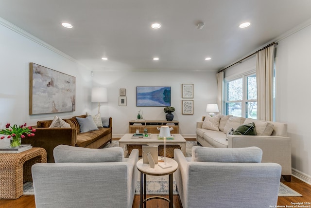 living room featuring hardwood / wood-style flooring and crown molding