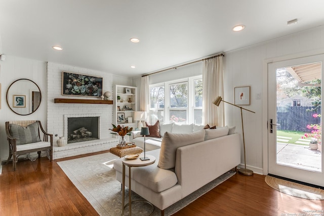 living room featuring a fireplace and dark wood-type flooring