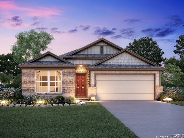 craftsman inspired home with a lawn and a garage