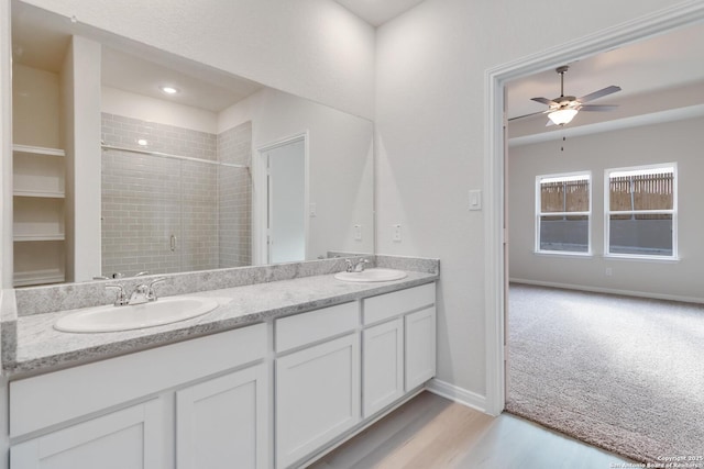142 Ashley Loop, San Antonio, TX 78253 - bathroom featuring double vanity, tiled shower, wood finished floors, and a ceiling fan