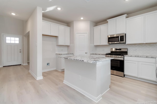142 Ashley Loop, San Antonio, TX 78253 - kitchen with appliances with stainless steel finishes, light wood-style flooring, a kitchen island, decorative backsplash, and recessed lighting