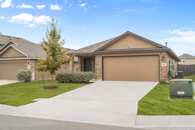 ranch-style home with cooling unit, a front yard, and a garage