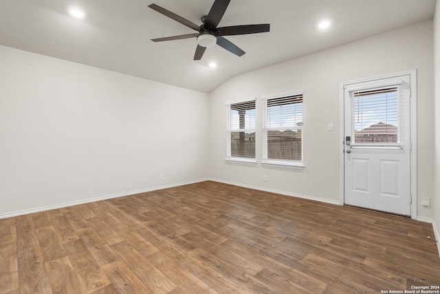 empty room featuring ceiling fan, wood-type flooring, and lofted ceiling