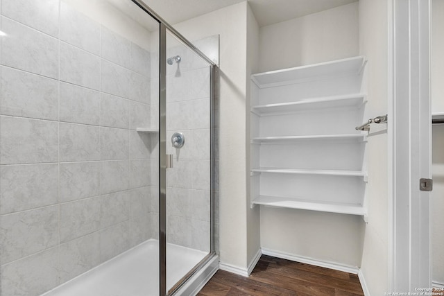 bathroom featuring wood-type flooring and walk in shower