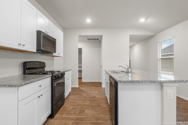 kitchen featuring hardwood / wood-style floors, black appliances, a center island with sink, sink, and white cabinetry