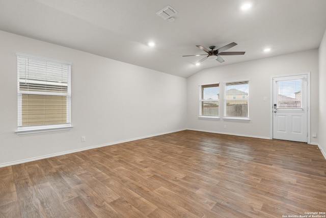 spare room with ceiling fan, light hardwood / wood-style floors, and vaulted ceiling