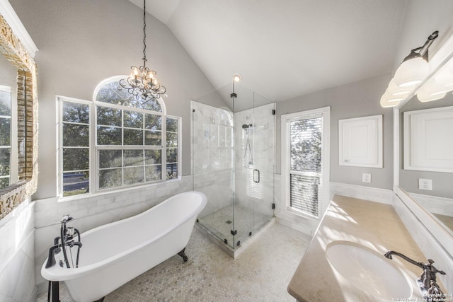 bathroom featuring vanity, lofted ceiling, an inviting chandelier, tile patterned flooring, and independent shower and bath