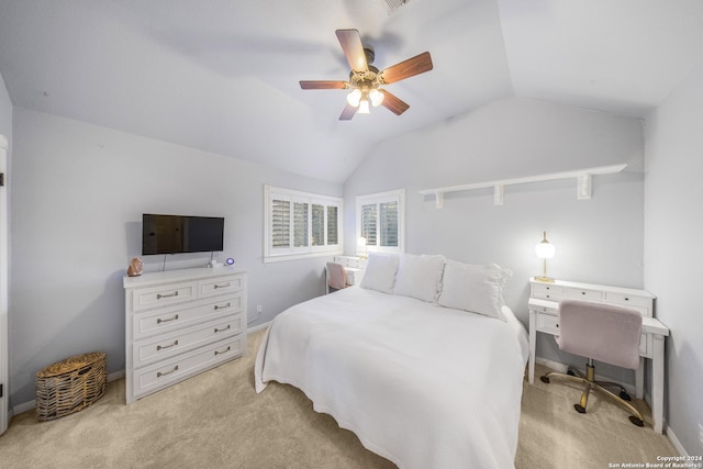 carpeted bedroom with ceiling fan and vaulted ceiling