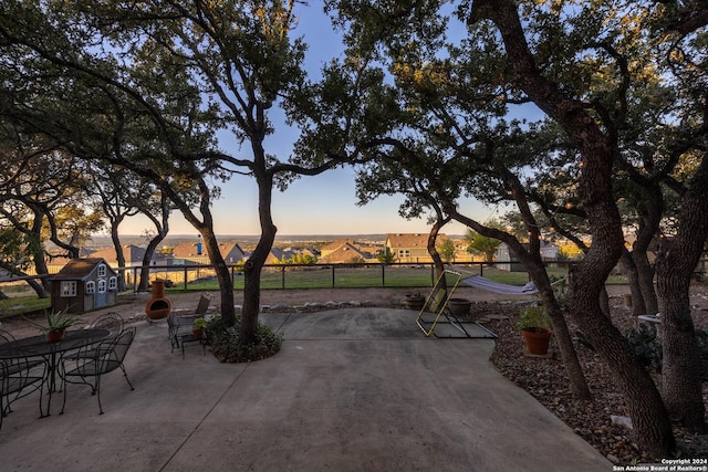 view of patio terrace at dusk