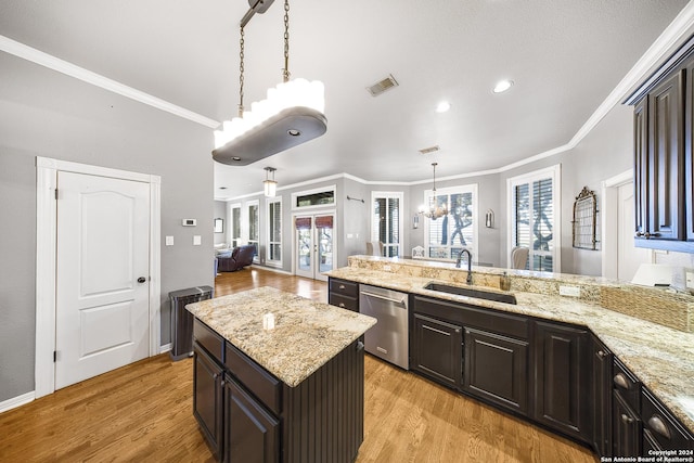 kitchen with ornamental molding, sink, pendant lighting, dishwasher, and light hardwood / wood-style floors