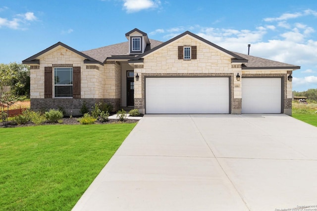 craftsman-style house featuring a garage and a front yard