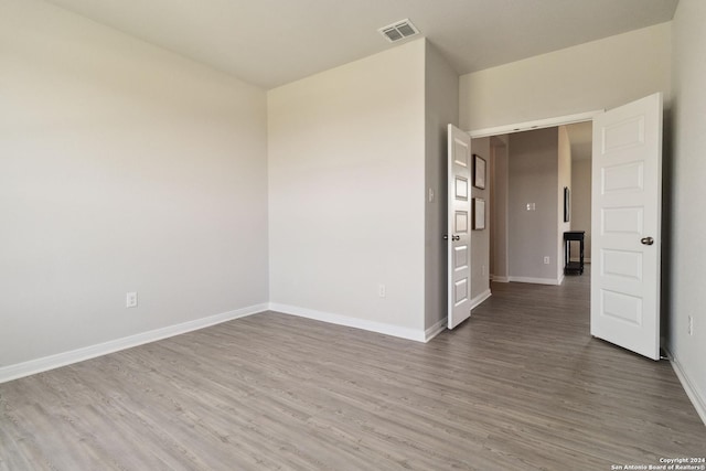 spare room with hardwood / wood-style floors