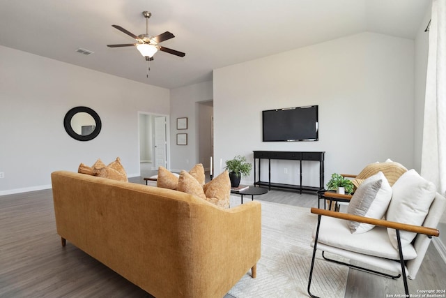 living room with ceiling fan, wood-type flooring, and vaulted ceiling