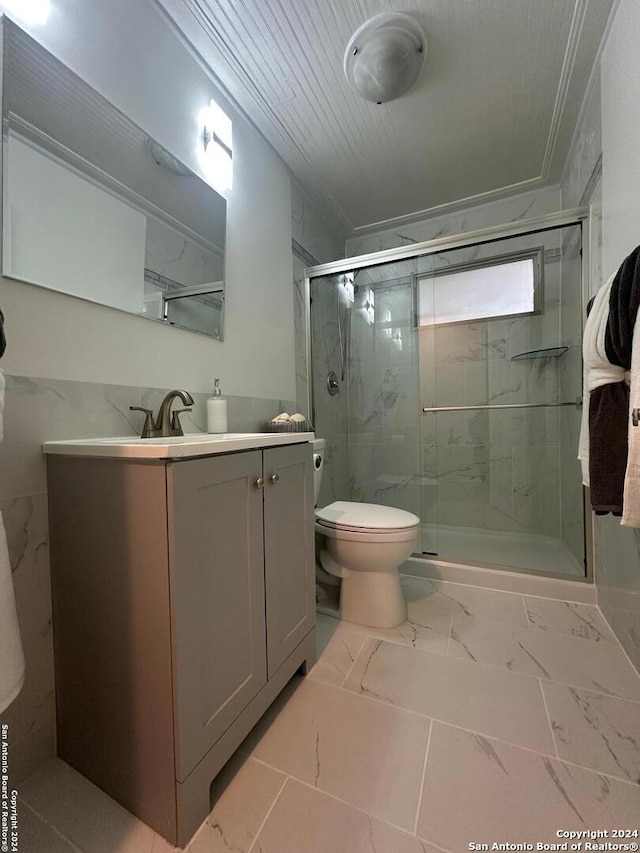 bathroom with tile patterned flooring, vanity, toilet, and an enclosed shower