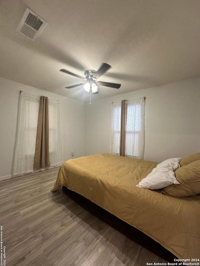 bedroom featuring ceiling fan and hardwood / wood-style flooring