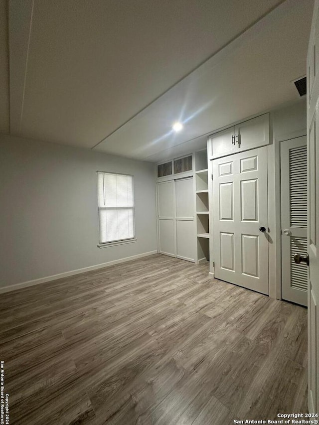 unfurnished bedroom featuring wood-type flooring