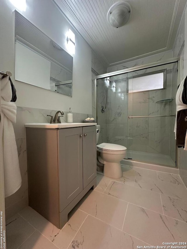 bathroom with tile patterned flooring, vanity, toilet, and walk in shower