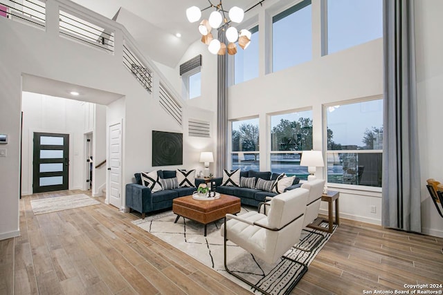 living room with a high ceiling and a chandelier