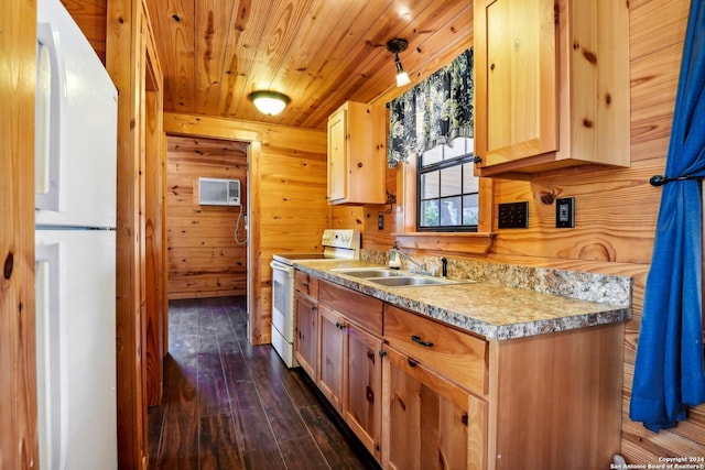 kitchen with dark hardwood / wood-style floors, white appliances, decorative light fixtures, wooden walls, and light brown cabinetry