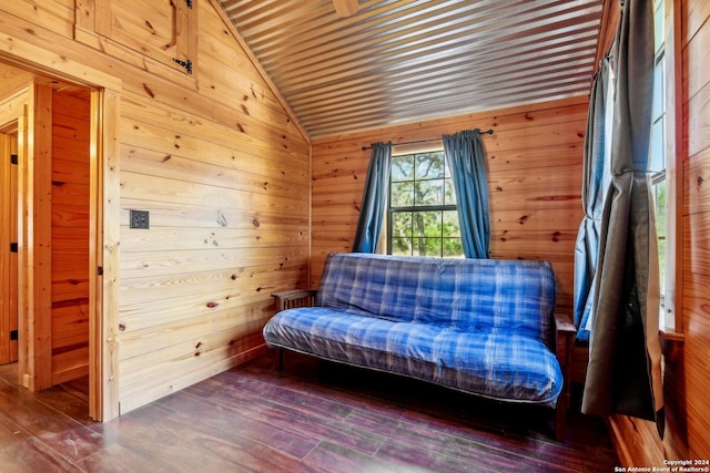 unfurnished room featuring dark hardwood / wood-style floors, wood walls, and lofted ceiling