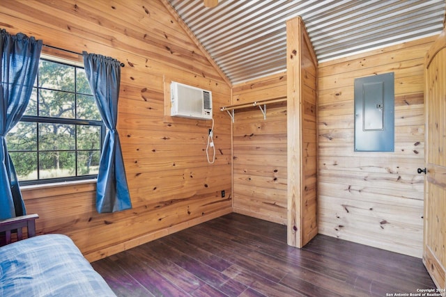 bedroom with lofted ceiling, dark wood-type flooring, electric panel, an AC wall unit, and wooden walls