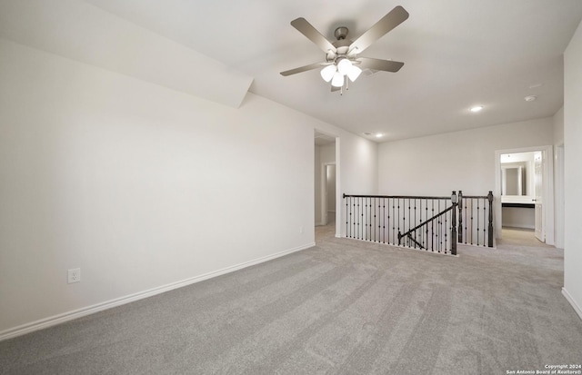 carpeted spare room featuring ceiling fan