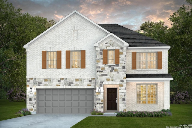 view of front of house featuring a garage and a lawn