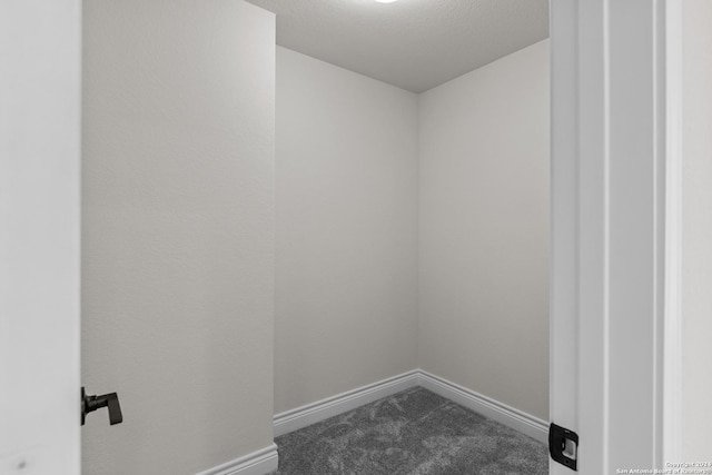 carpeted empty room featuring a textured ceiling