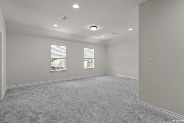 unfurnished room featuring light carpet