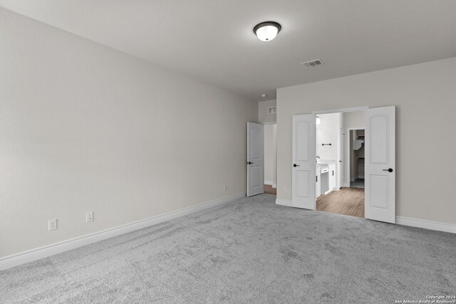 unfurnished bedroom with light colored carpet