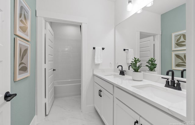 bathroom featuring vanity and tiled shower / bath