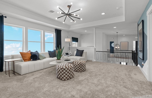 carpeted living room featuring an inviting chandelier, a raised ceiling, and ornamental molding