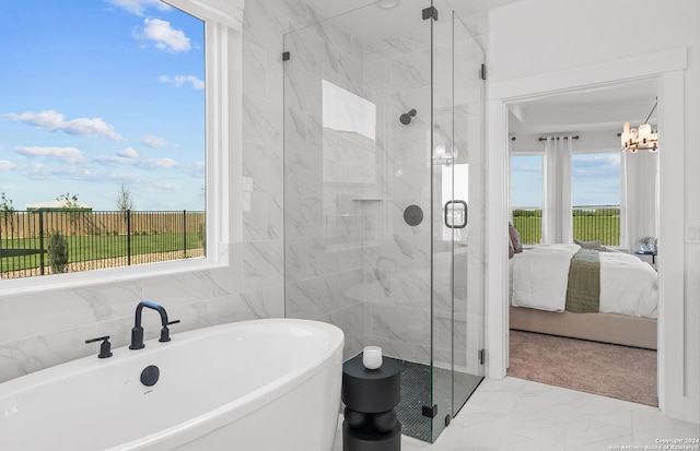 bathroom featuring plus walk in shower, tile walls, and a notable chandelier