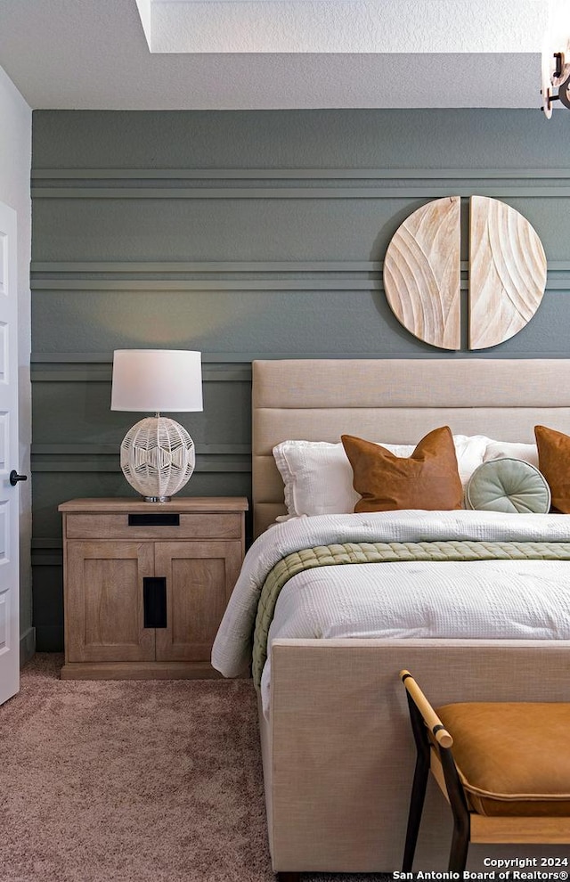 bedroom featuring carpet and a textured ceiling