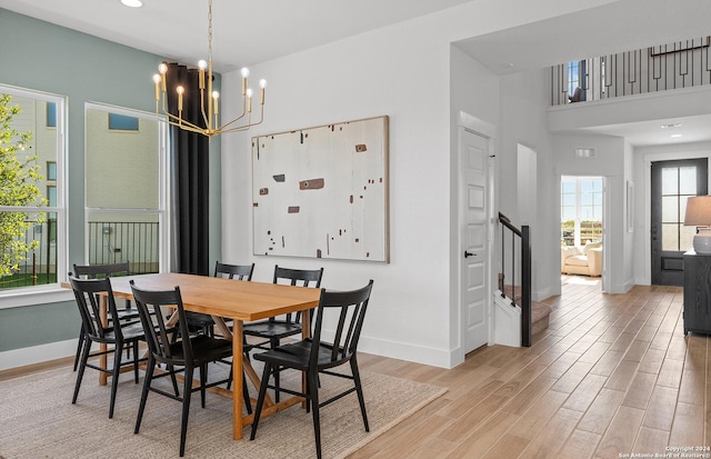 dining room featuring light hardwood / wood-style floors and a notable chandelier